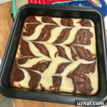 Delicious Cream Cheese Swirl Brownies with a rich chocolate base and creamy topping.