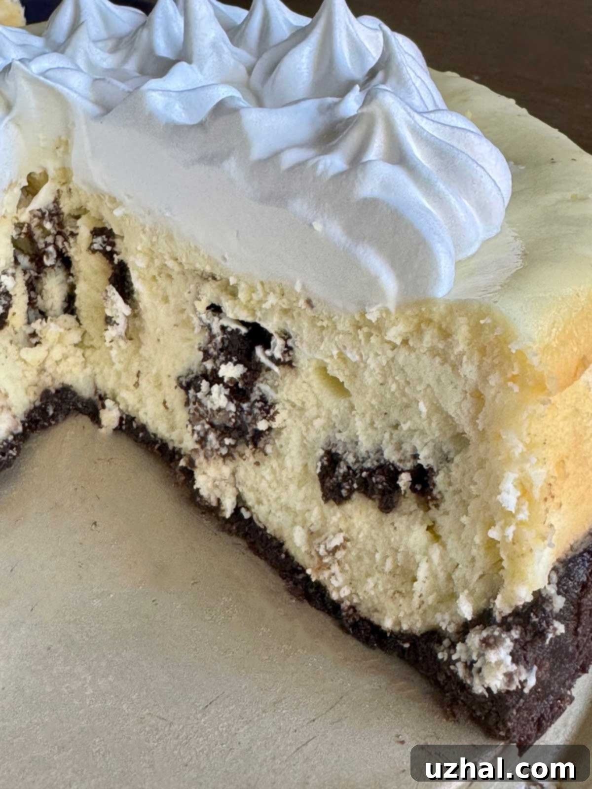 A visually stunning, creamy and fluffy Oreo Cheesecake, featuring whipped egg whites folded into the batter, showcasing its delightful texture.