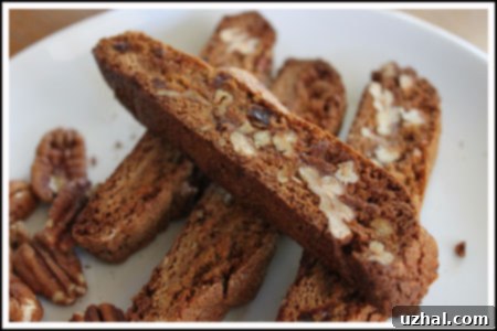 Crispy gingerbread biscotti, perfect for dipping, dusted lightly with powdered sugar.