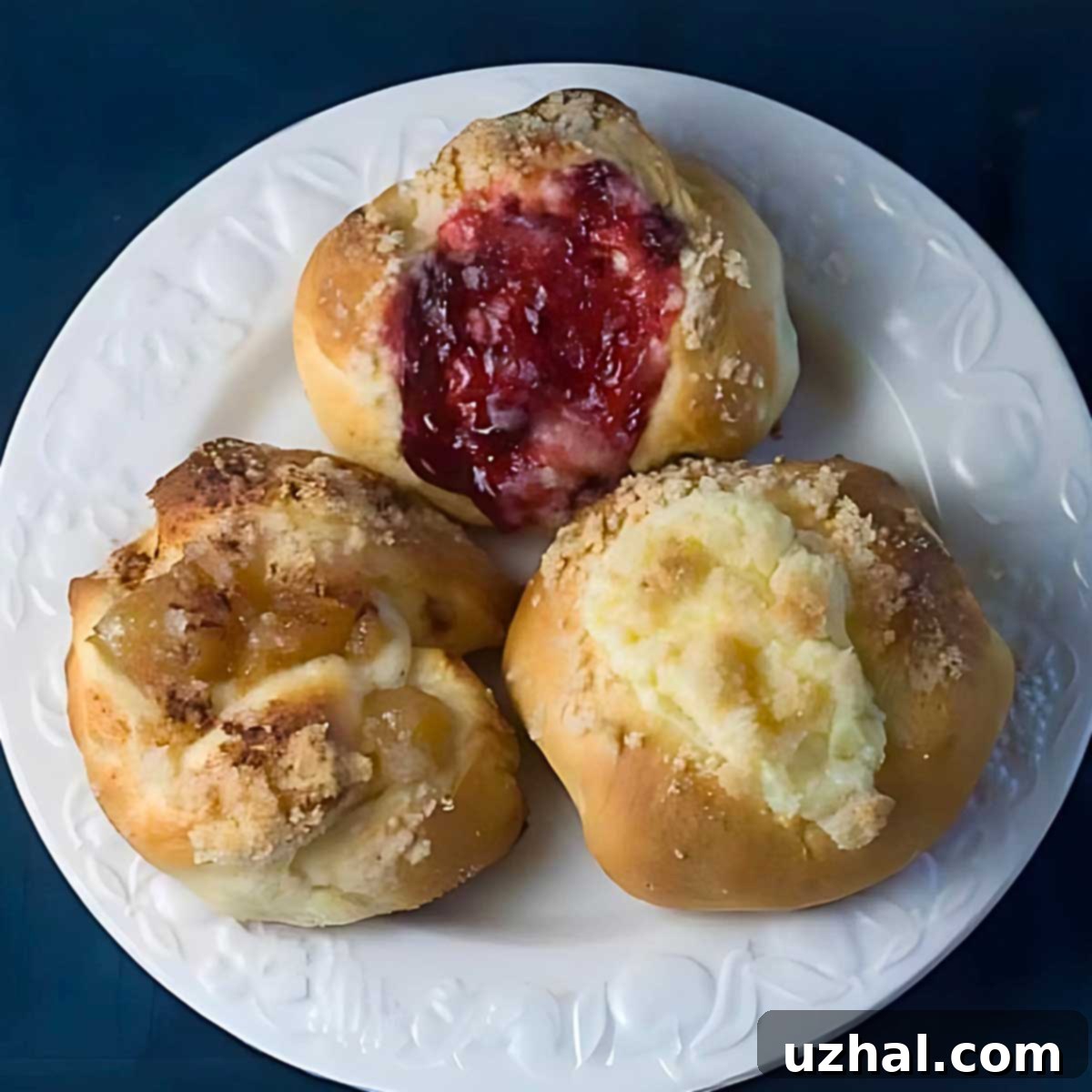 Freshly baked Kolaches with various fillings, including cream cheese, apple, and berry jelly.