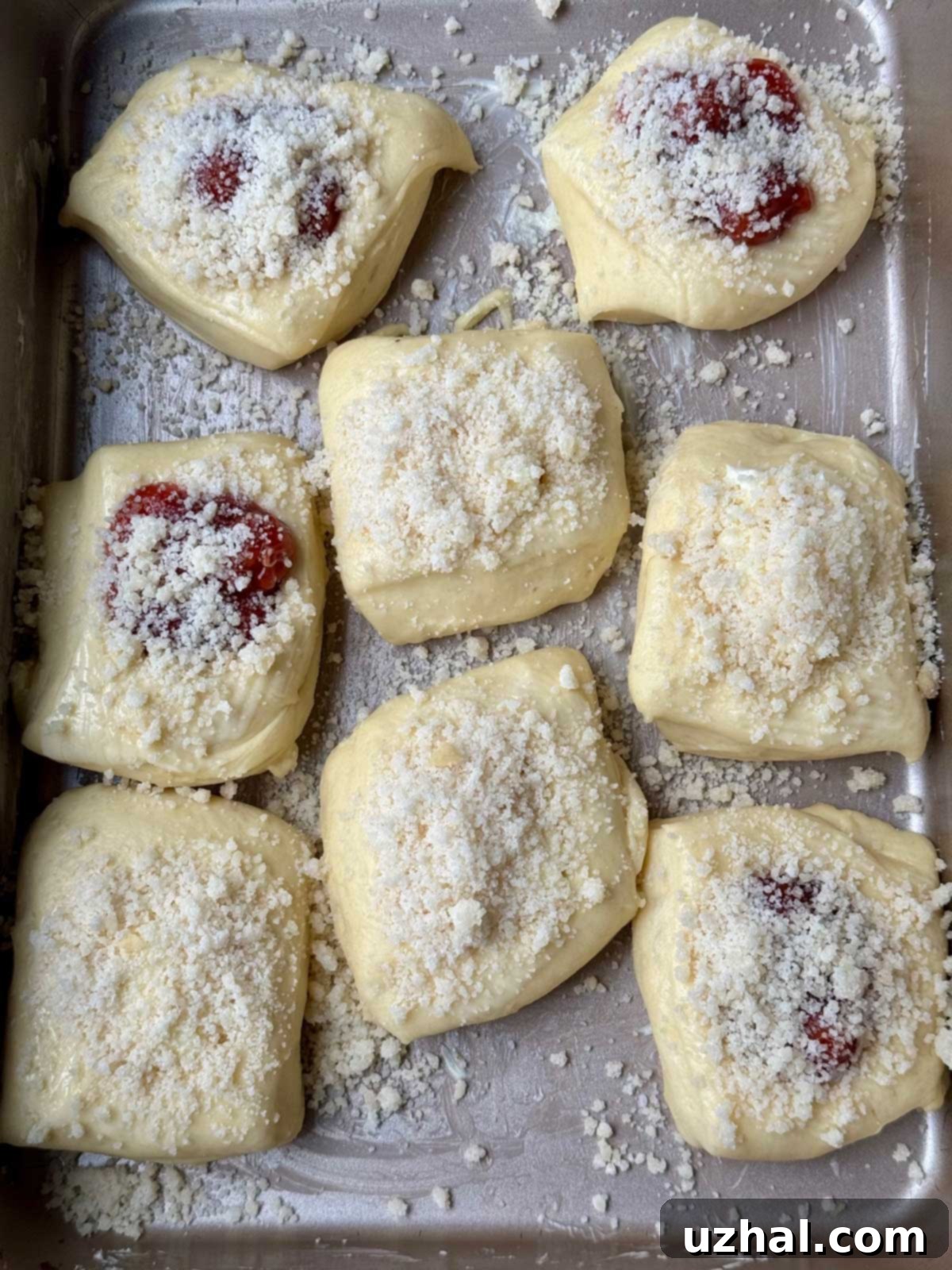 Unbaked kolaches in a pan showing spacing before being baked.