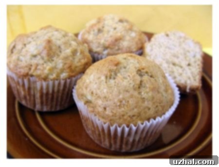 Freshly baked, golden-brown pear muffins arranged beautifully on a cooling rack, highlighting their moist texture and inviting aroma.