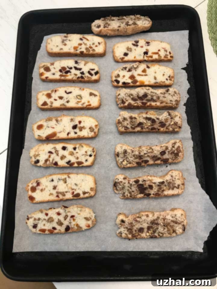 Sliced biscotti thins arranged on a baking sheet for second bake
