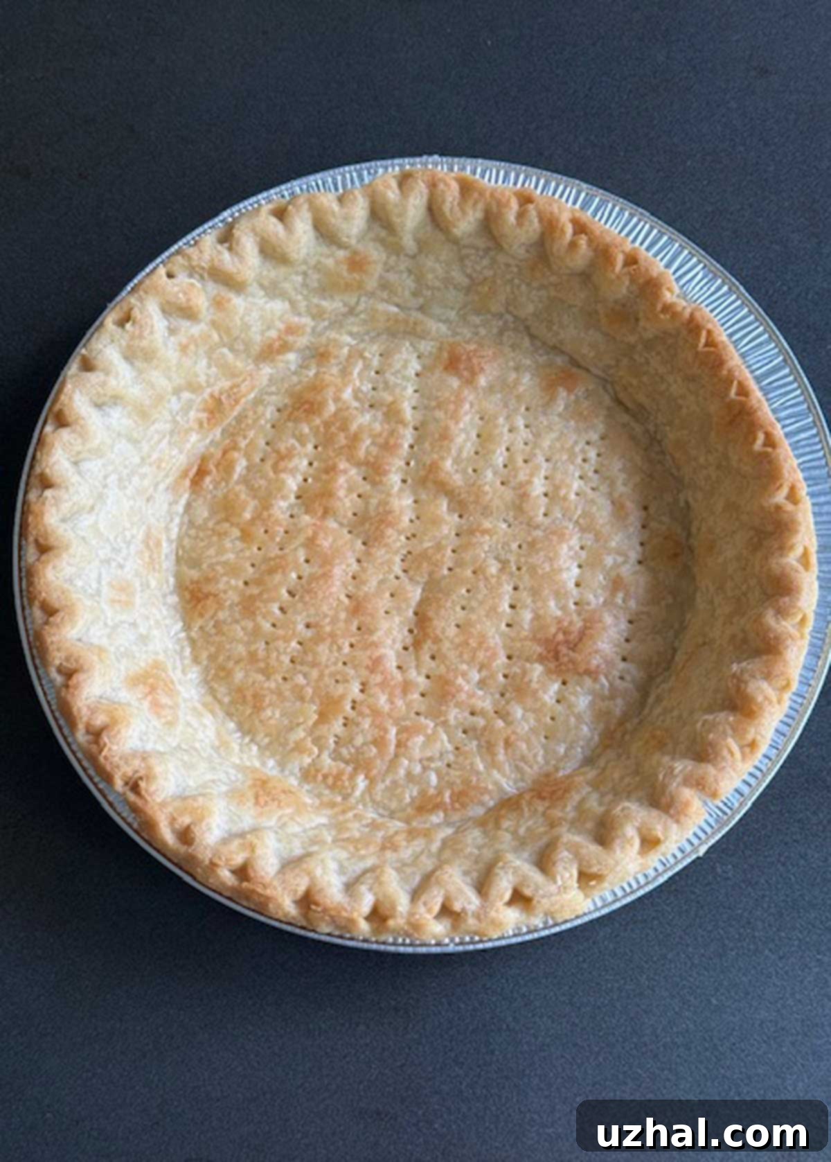 A perfectly baked frozen store-bought pie crust called Marie Callender's, ready for filling.