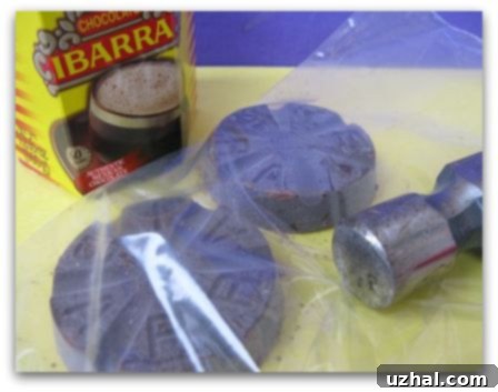 A block of Ibarra Mexican chocolate, unwrapped and ready for chopping, highlighting its distinct texture and packaging.
