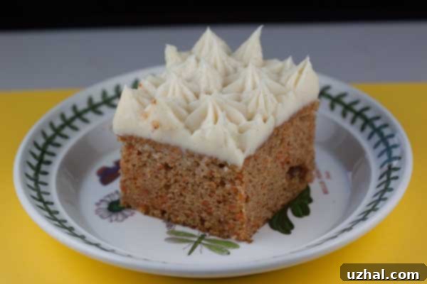 A slice of Sour Cream Carrot Cake with cream cheese frosting.