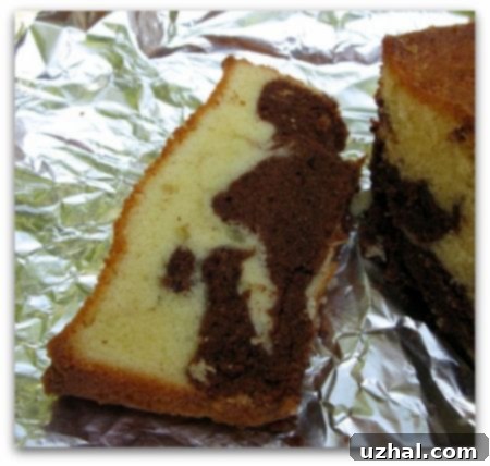 Classic Marbled Pound Cake baked in a loaf pan, showing its comforting shape.