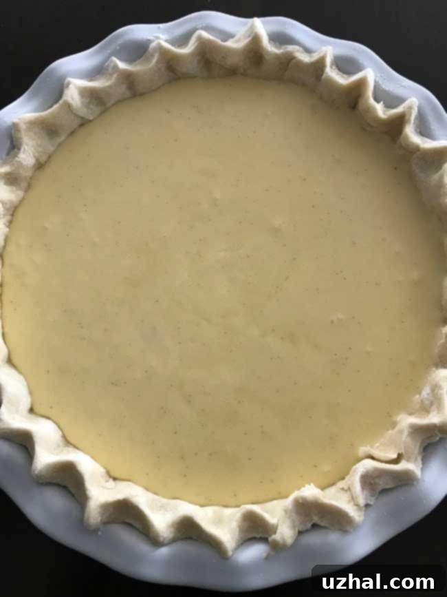 Unbaked Buttermilk Pie filling in a pie crust, ready for the oven