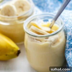 Vanilla Bean Banana Pudding recipe in a white bowl, showing layers and whipped cream