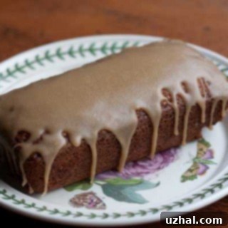 Slice of Applesauce Loaf Cake with caramel icing and spices
