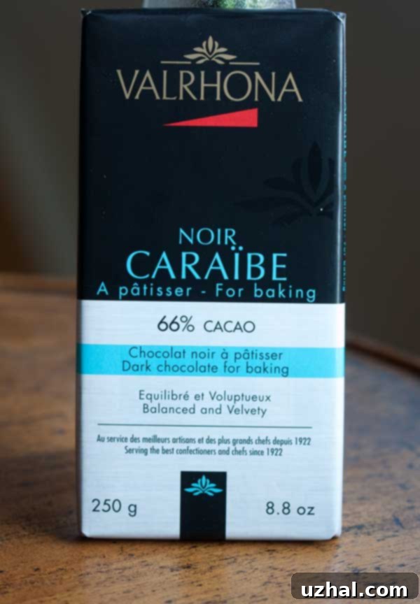 A large block of Valrhona Caraibe dark chocolate, ready to be chopped for baking.