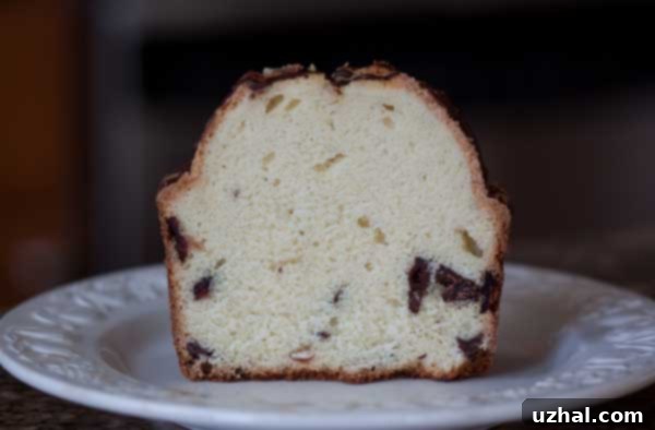 Another perspective of a high-rising cream cake, highlighting its golden crust and impressive volume from a loaf pan bake.