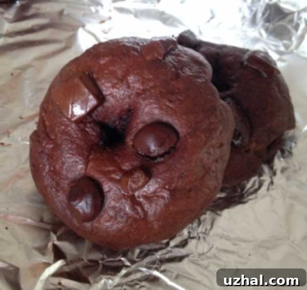 Stack of double chocolate bagels with melted chocolate drizzle on top.