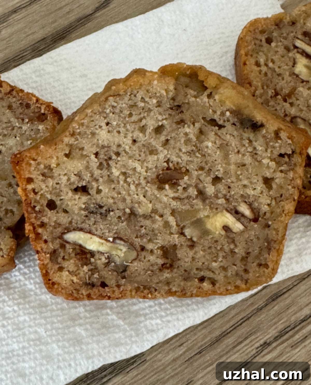A perfectly sliced piece of Honey Banana Bread, showcasing its moist texture and golden-brown crust.