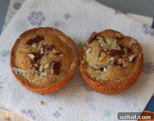 Close-up of fluffy homemade peach muffins, some with chopped pecans
