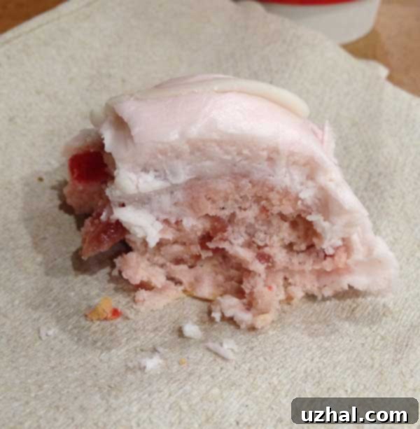 A plate of freshly baked Meatball Cookies, some with white icing