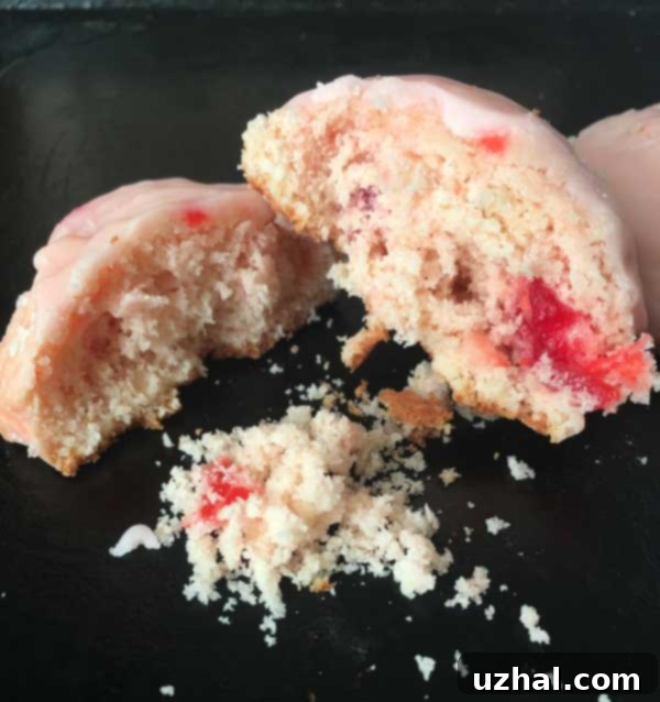 Close-up of a pink Meatball Cookie with shiny cherry icing