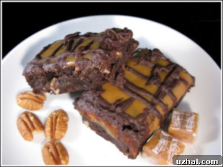Decadent Caramel Topped Brownies with a glossy caramel layer and a chocolate drizzle, ready to be served.
