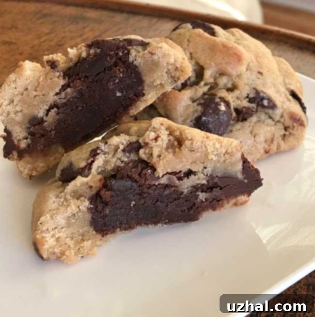Freshly baked Brownie Stuffed Chocolate Chip Cookies cooling on a rack, ready to be enjoyed.