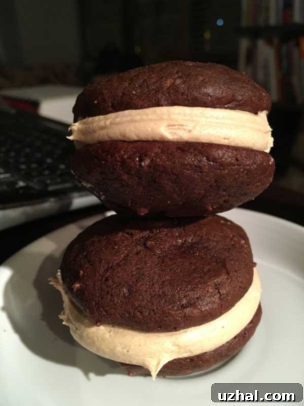 Close-up of whoopie pie cookies before filling, showing their soft, cake-like texture, arranged on a baking sheet