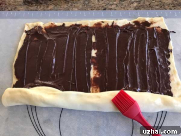 Rich Chocolate Swirl Loaf 5 Close-up of chocolate swirl bread dough being twisted into a beautiful loaf shape.