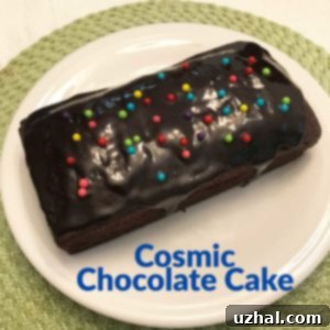 Cosmic Chocolate Cake with shiny glaze and colorful sprinkles