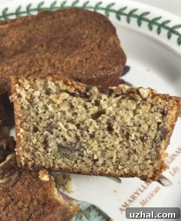 A beautifully golden-brown loaf of Dominique Ansel banana bread, fresh from the oven and ready to be sliced.