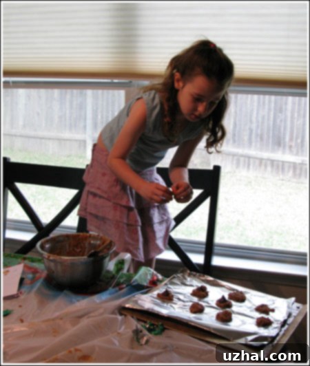 Fuzz putting Kisses on cookies.