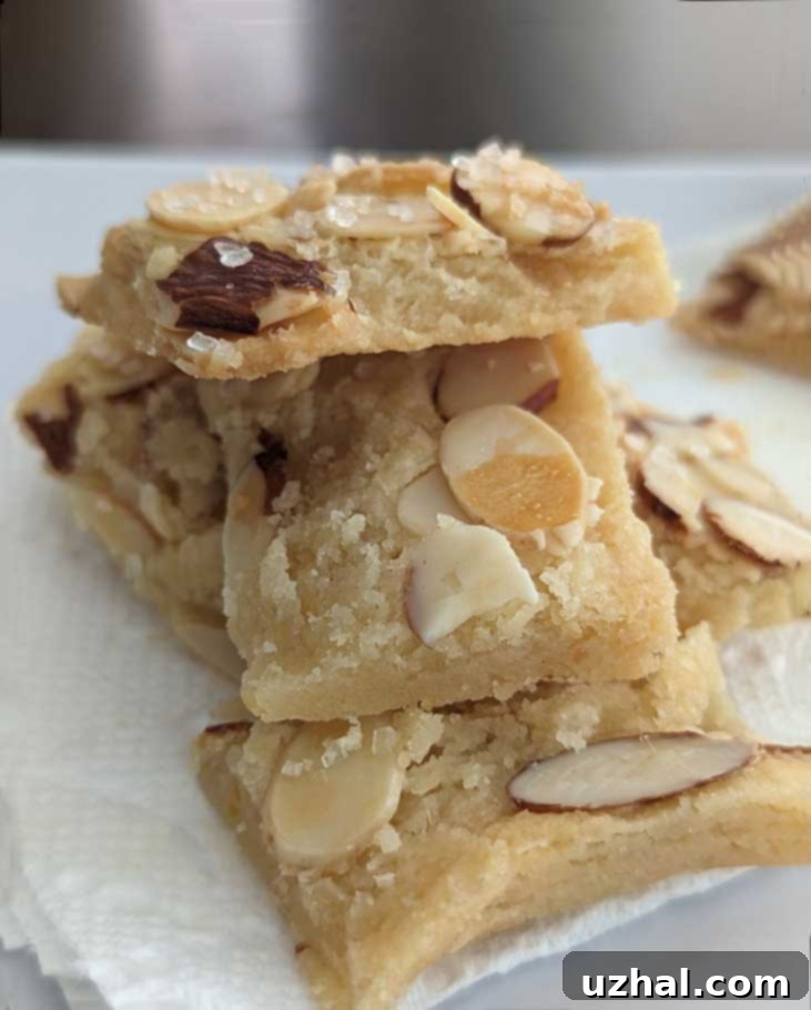 Golden brown Michelle Obama's Shortbread cookies with almond slivers and citrus zest, ready to be enjoyed.