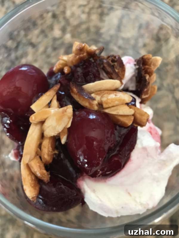 Classic Cherry Fool dessert in a glass with whipped cream and almonds