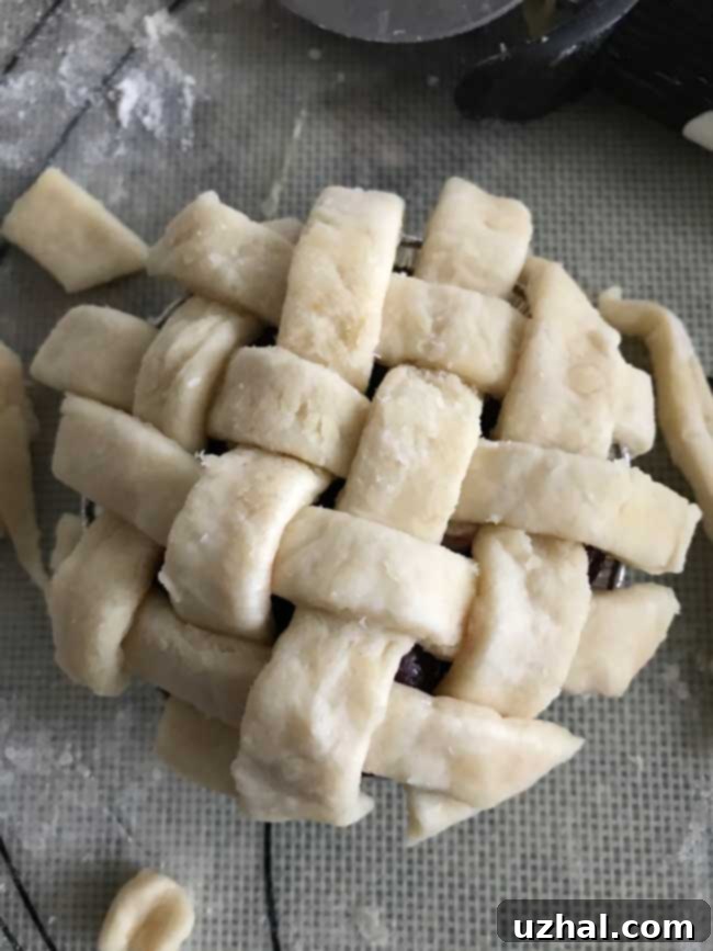 Boiled over mini cherry pie in a 3-inch tin