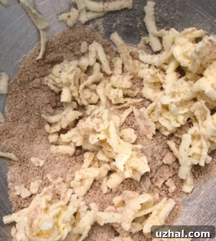 Close-up of streusel scones dough showing visible shreds of cold butter.