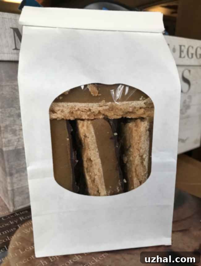White tin tie bag filled with Millionaire Shortbread Bars, showing the product through a clear window.