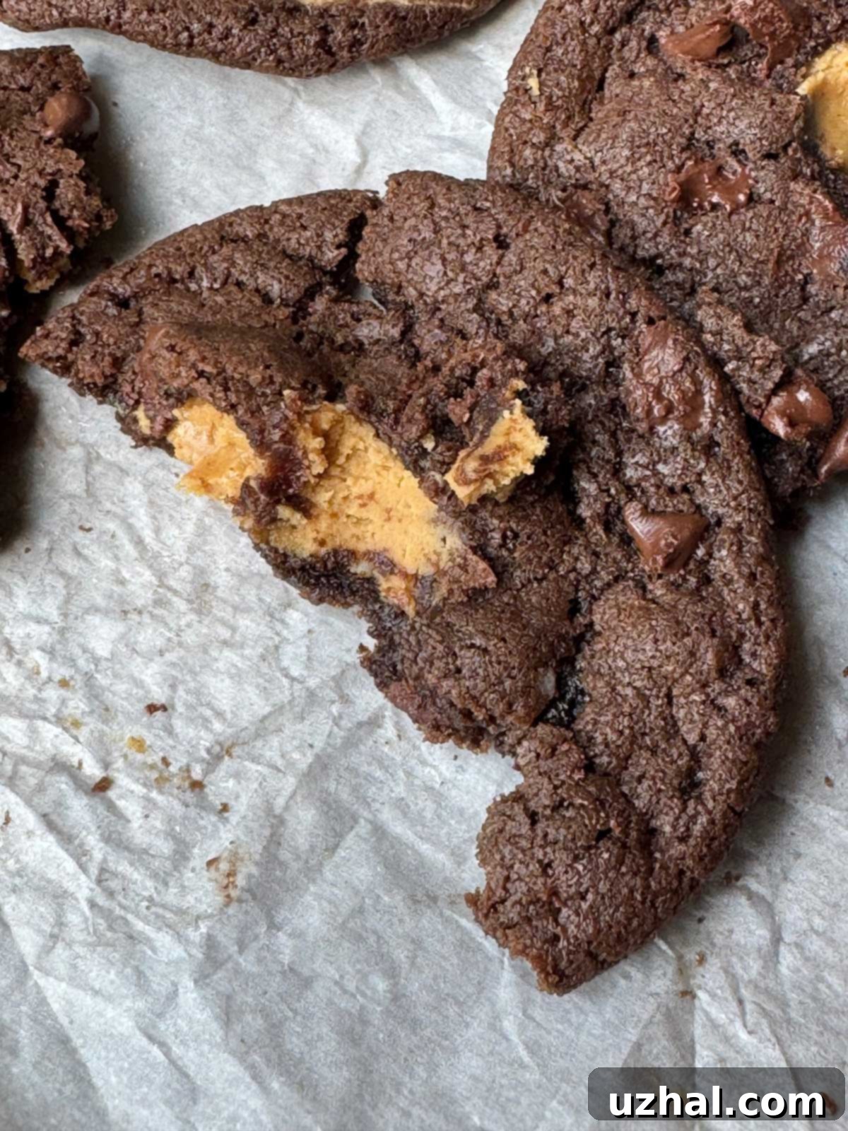 Peanut Butter Stuffed Chocolate Cookies recipe, showcasing a beautifully baked cookie with a peek of peanut butter filling.