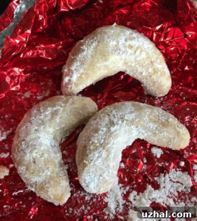 Almond Crescents made with Solo brand pie filling, showcasing their perfect crescent shape and light dusting of powdered sugar.