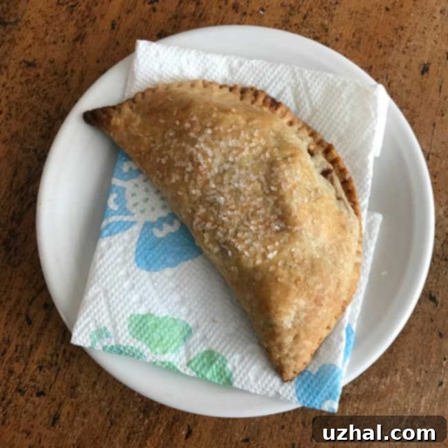 apple hand pies arranged on a baking sheet