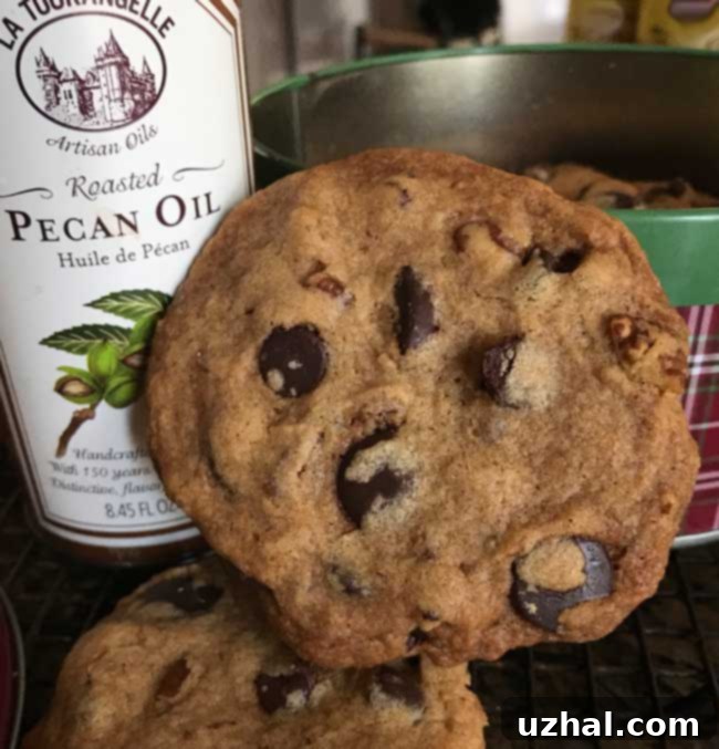 Deliciously crunchy roasted pecan chocolate chip cookies stacked on a plate