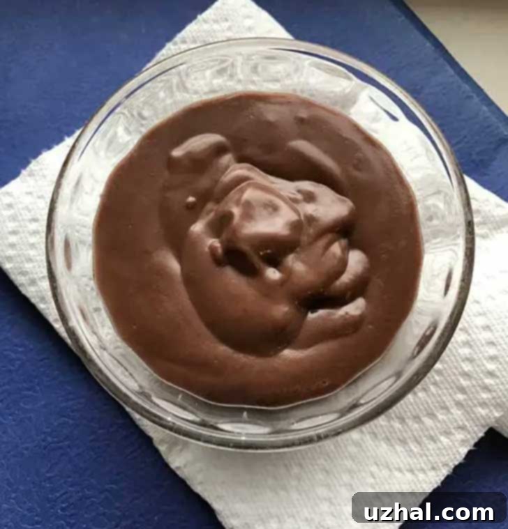Decadent homemade chocolate pudding served in a small custard cup, perfect for two