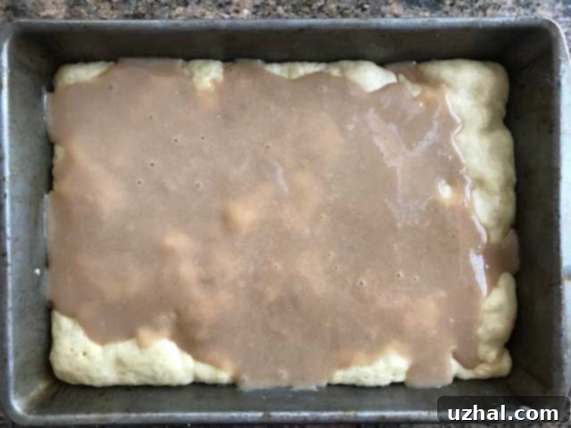 Swedish Ripple Cake dough pressed into a pan, with the caramel topping ready to be spread.