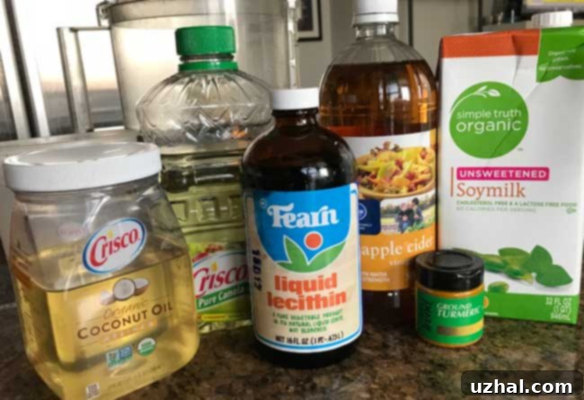 Essential ingredients laid out for making creamy homemade vegan butter, including coconut oil, soy milk, and apple cider vinegar.