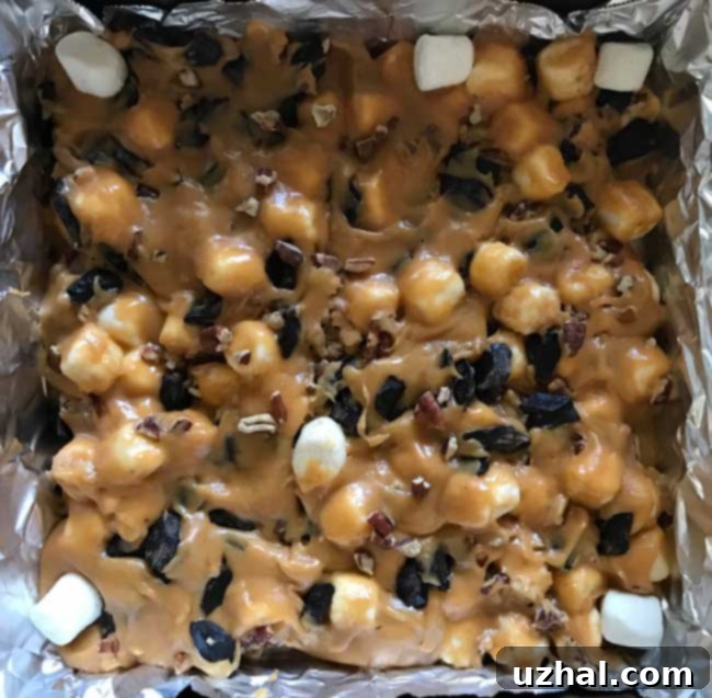 Toasted Marshmallow Dream Blondies 3 Unbaked Chewy Marshmallow Blondies batter, showing the rich blend of melted butterscotch, brown sugar, and visible marshmallow pieces mixed in, ready for baking.