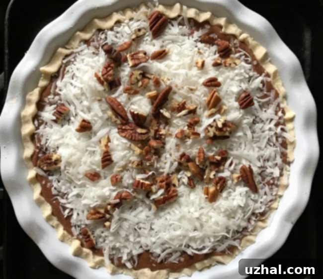 German Chocolate Cream Pie entering the oven, showing the unbaked filling and topping