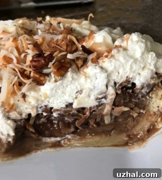 Finished German Chocolate Pie, generously topped with whipped cream, coconut, and pecans