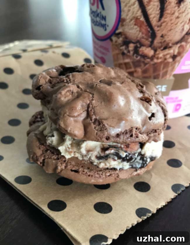 Brownie Chip Meringues transformed into an ice cream sandwich, filled with a generous scoop of ice cream.