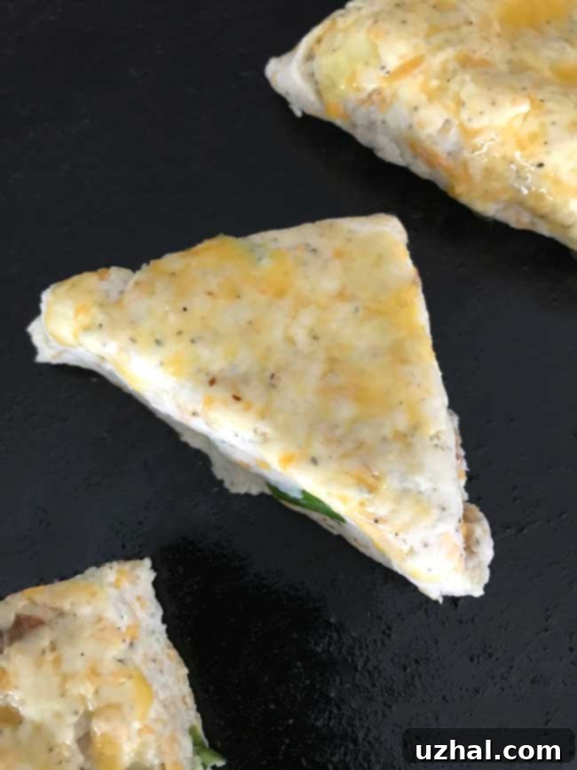 A baking sheet with unbaked Mini Cheddar Bacon Scones, ready for the oven