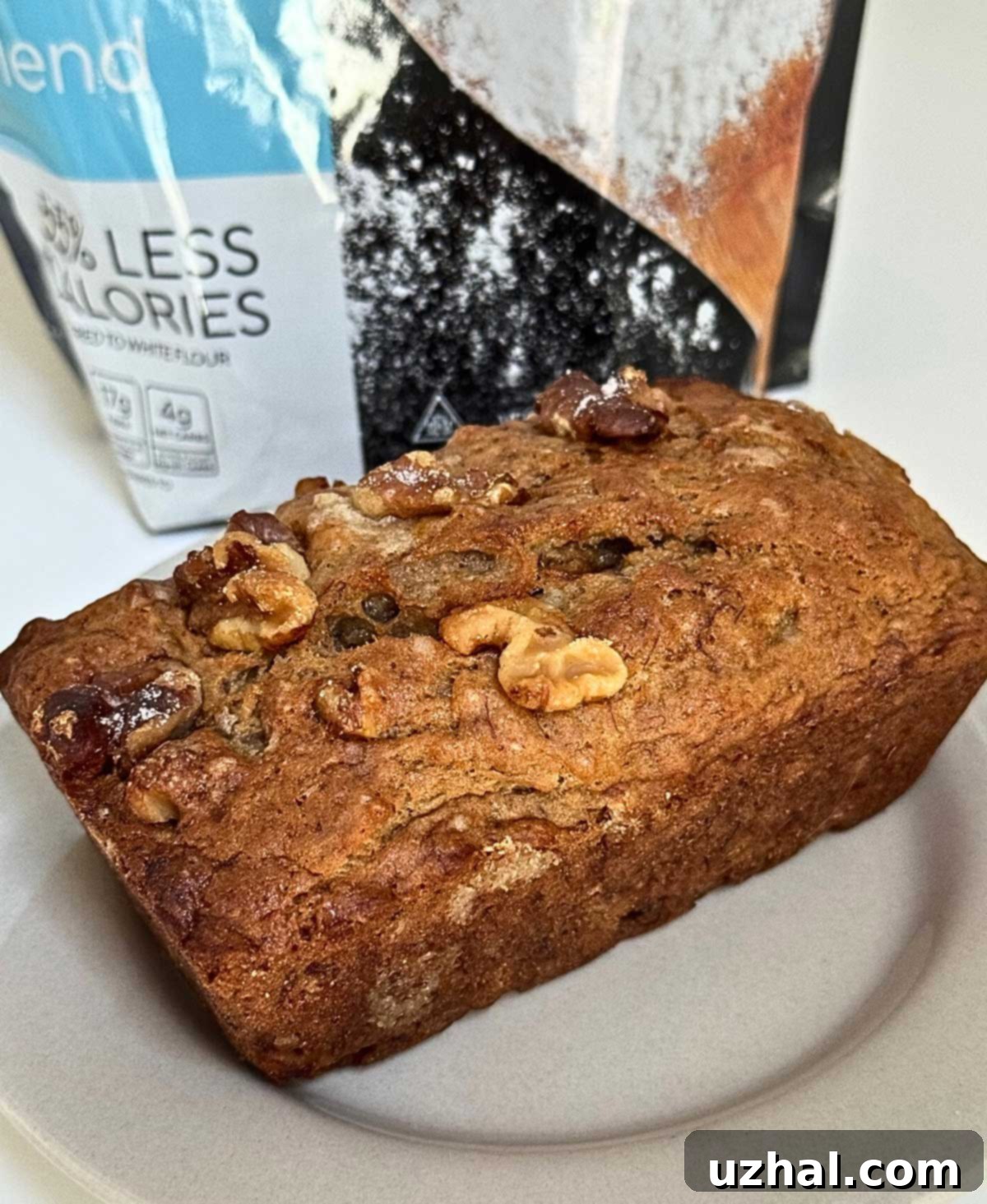 A small loaf of banana bread made with one banana and Fiber Gourmet flour blend, showing its golden-brown top.