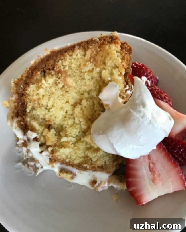 slice of white chocolate Bundt cake with cream cheese frosting