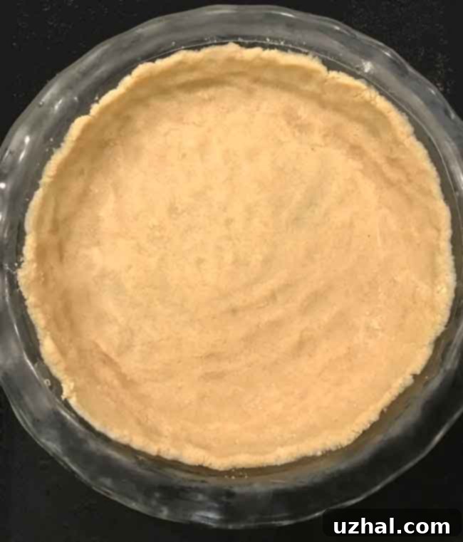 A perfectly golden-brown almond flour pie crust, ready for filling.