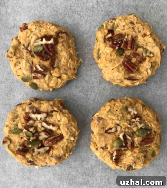 A stack of freshly baked Pumpkin Bread Breakfast Cookies with oats and pepitas