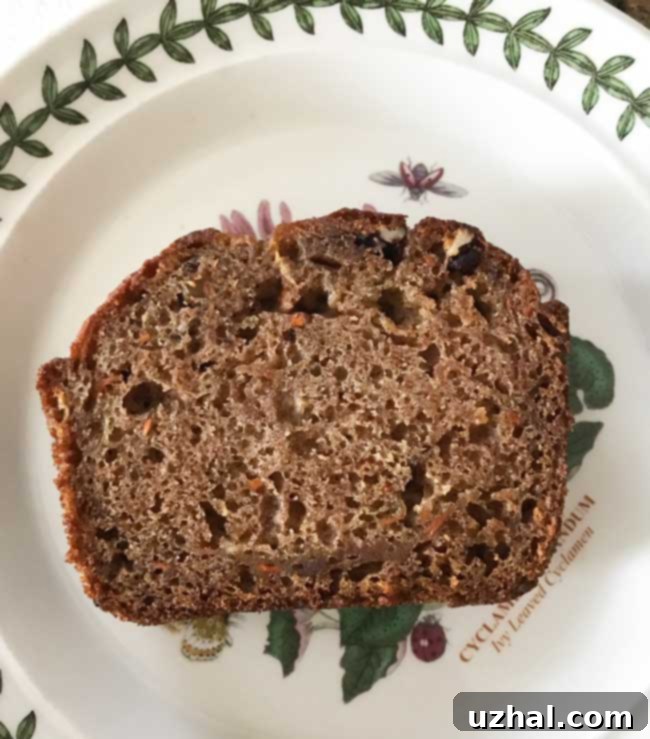 Freshly baked Garden Harvest Cake loaf on a cooling rack, showcasing its golden brown crust and rich texture.